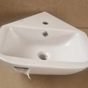 petit lavabo d'angle en céramique blanche, de marque Sanindusa