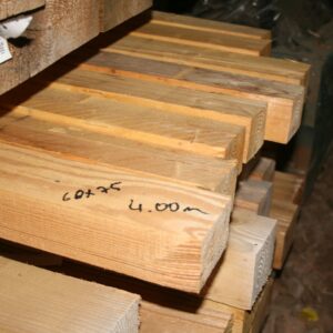 Pile de chevrons en bois clair de 4 m, section 60 x 75 mm notée au marqueur sur la pièce du premier plan